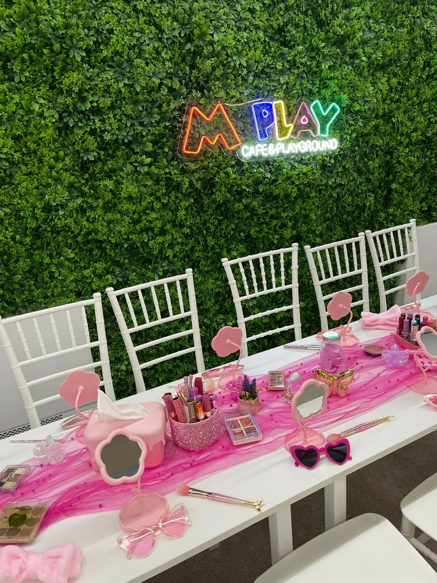 Make-up palettes, lipsticks and little mirrors on the pink table